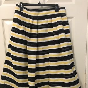 Yellow black and white striped skirt.